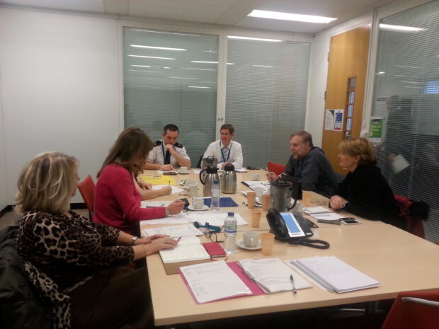 Foreign registered vehicles working group of 6 people sitting around a table