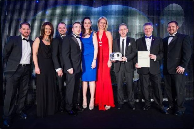 Paul Cattrol (2nd from right) with his team on stage accepting the  procurement team of the year award