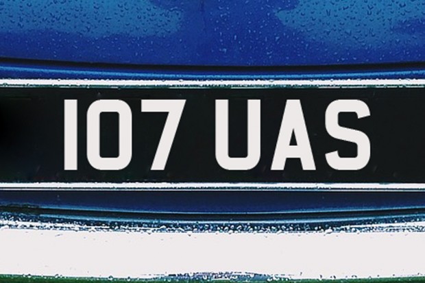 Black number plate with silver numbers and letters displaying 107 UAS