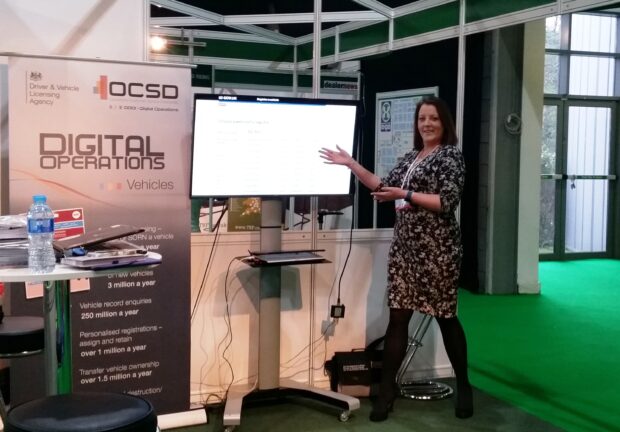 DVLA's Leanne Jones at an exhibition stand showing a presentation on a screen