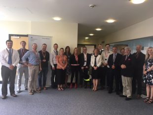 A group of people from the Charity forum standing in a semi-circle