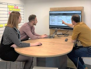 3 DVLA staff in meeting looking at a screen