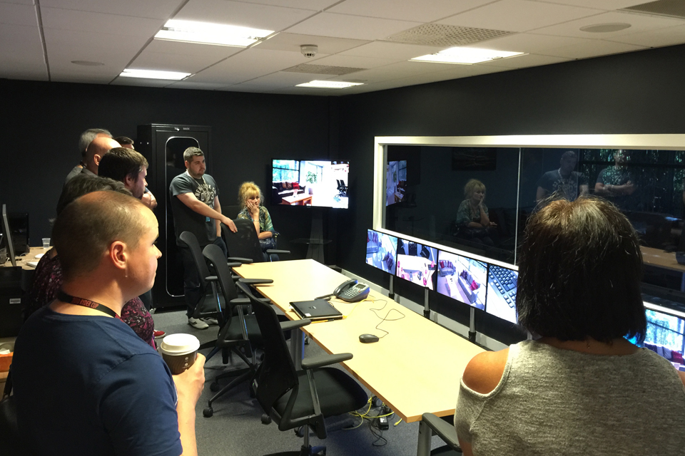 Picture of six people watching users at DVLA's user experience lab