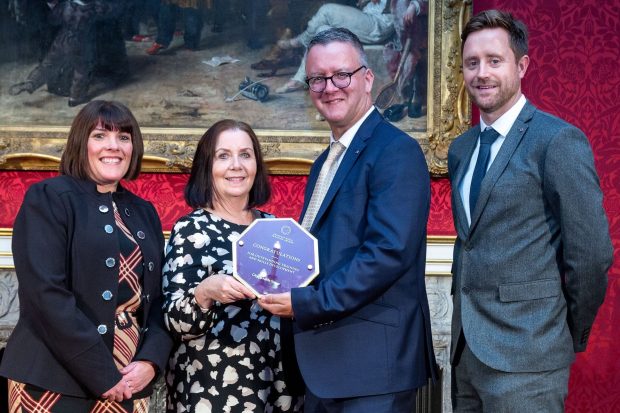 4 representatives from DVLA's Leap programme standing in a row holding their Princess Royal Training Award 