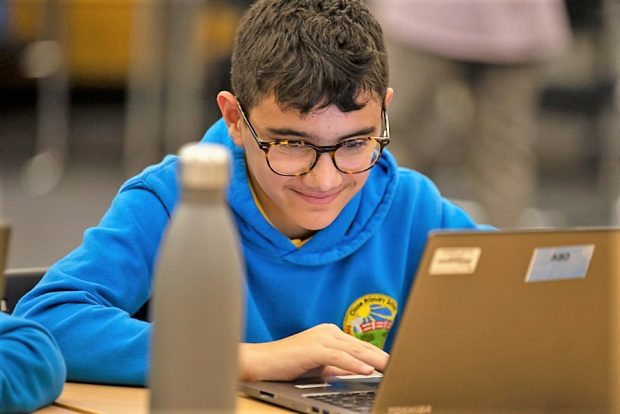 Boy from Clase Primary School on laptop