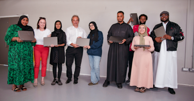STEM ambassadors handing over DVLA donated laptops